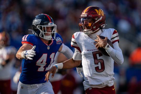 Washington Commanders quarterback Jayden Daniels (5) runs with the ball while being chased by New York Giants linebacker Micah McFadden (41) during a game between the New York Giants and the Washington Commanders at MetLife Stadium in East Rutherford on Sunday, Nov. 3, 2024.