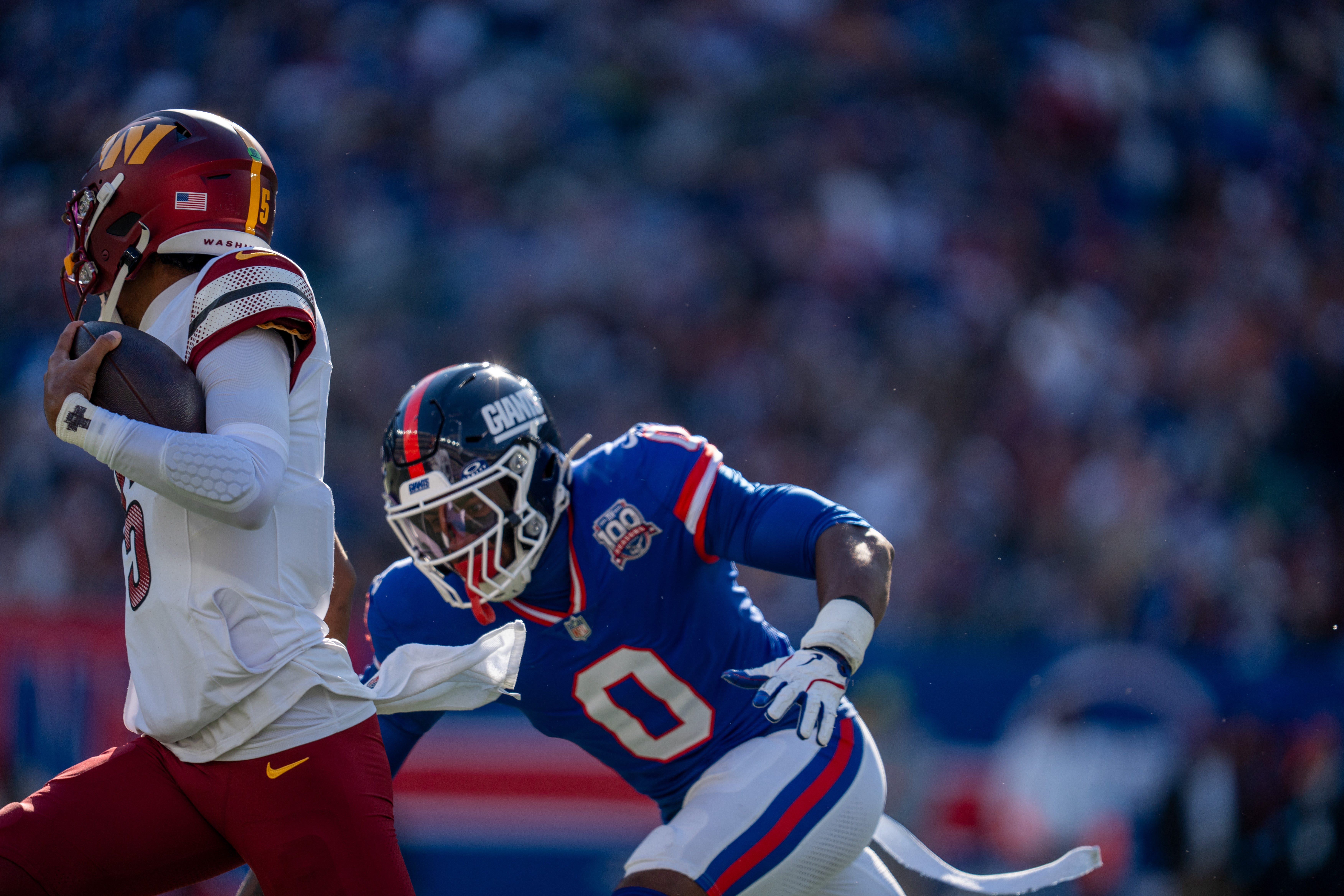 New York Giants linebacker Brian Burns (0) chases down Washington Commanders quarterback Jayden Daniels (5) during a game between the New York Giants and the Washington Commanders at MetLife Stadium in East Rutherford on Sunday, Nov. 3, 2024.