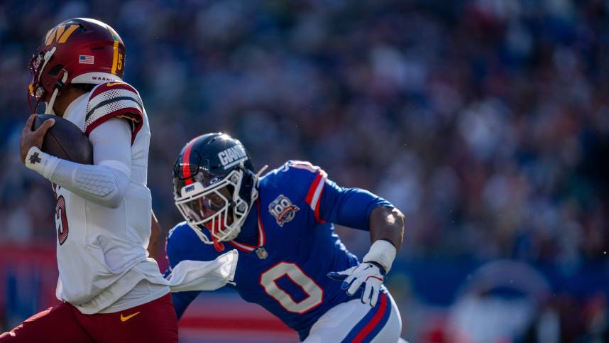 New York Giants linebacker Brian Burns (0) chases down Washington Commanders quarterback Jayden Daniels (5) during a game between the New York Giants and the Washington Commanders at MetLife Stadium in East Rutherford on Sunday, Nov. 3, 2024.