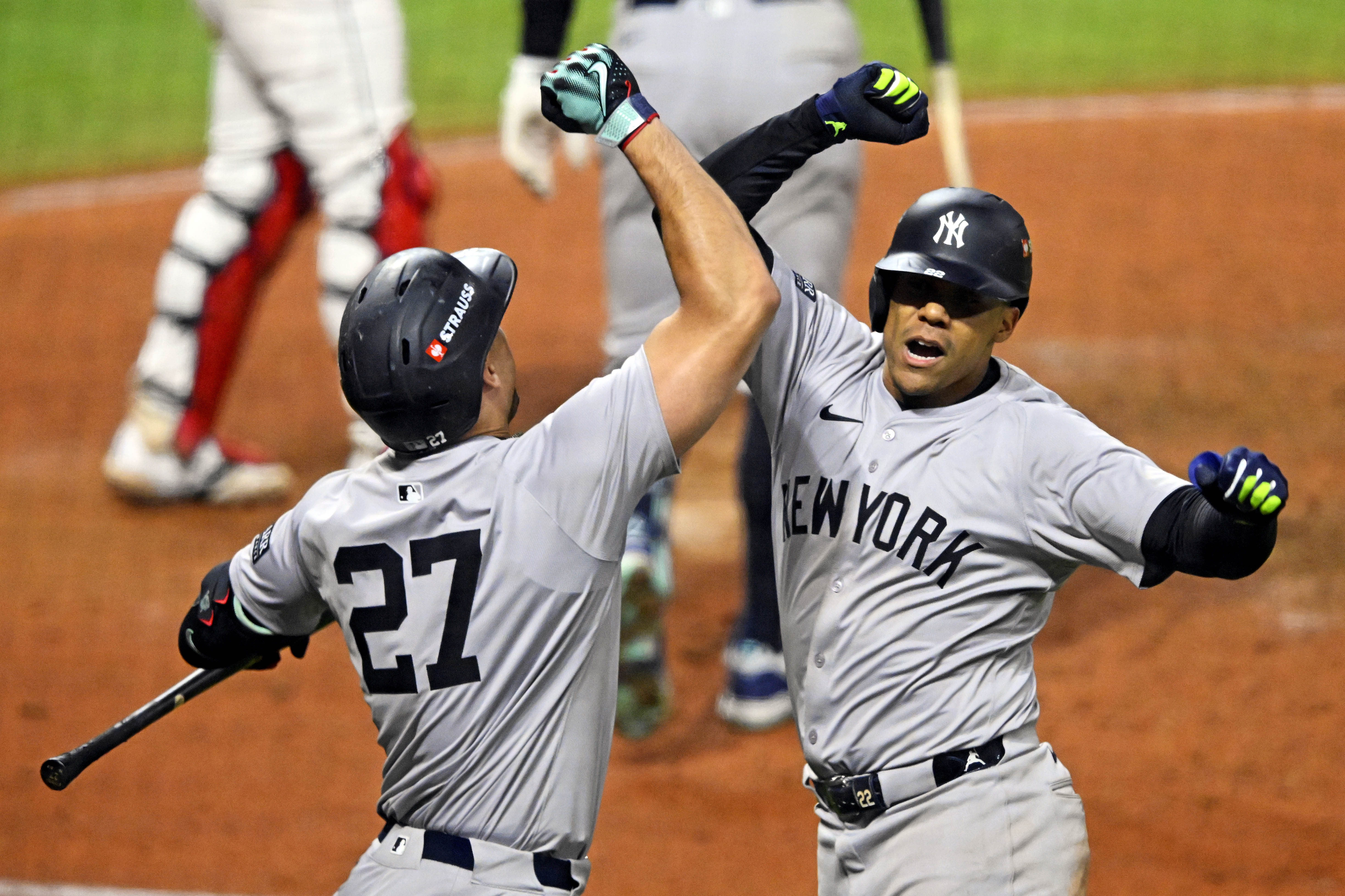 Oct 19, 2024; Cleveland, Ohio, USA; New York Yankees outfielder Juan Soto (22) celebrates with designated hitter Giancarlo Stanton (27) after hitting a three run home run during the tenth inning against the Cleveland Guardians during game five of the ALCS for the 2024 MLB playoffs at Progressive Field. Mandatory Credit: David Richard-Imagn Images