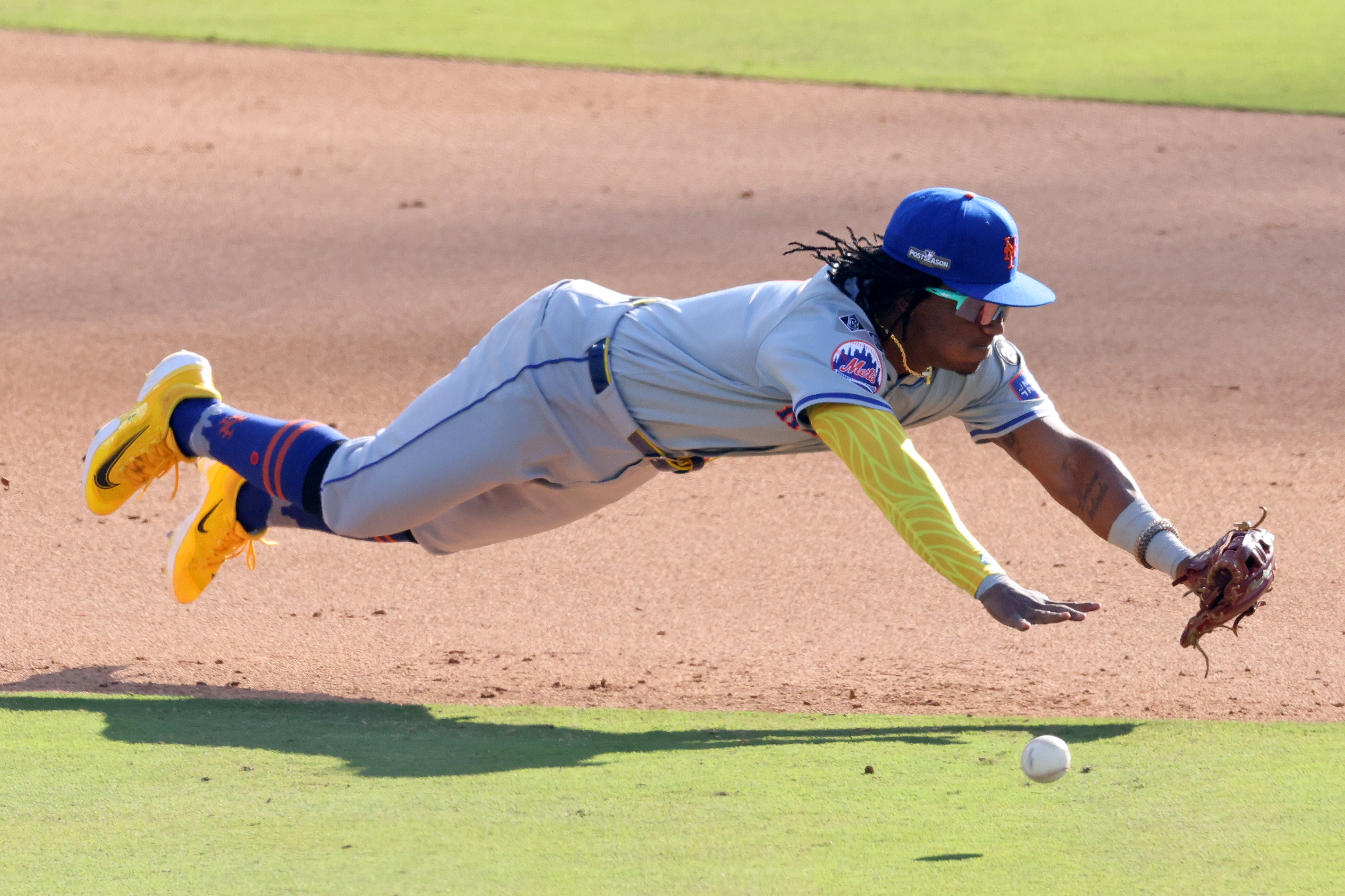 Oct 14, 2024; Los Angeles, California, USA; New York Mets shortstop Luisangel Acuna (2) attempts to field a ground ball against the Los Angeles Dodgers in the eighth inning during game two of the NLCS for the 2024 MLB Playoffs at Dodger Stadium. Mandatory Credit: Jason Parkhurst-Imagn Images