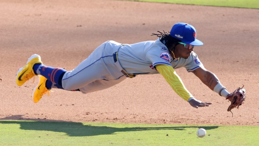 Oct 14, 2024; Los Angeles, California, USA; New York Mets shortstop Luisangel Acuna (2) attempts to field a ground ball against the Los Angeles Dodgers in the eighth inning during game two of the NLCS for the 2024 MLB Playoffs at Dodger Stadium. Mandatory Credit: Jason Parkhurst-Imagn Images