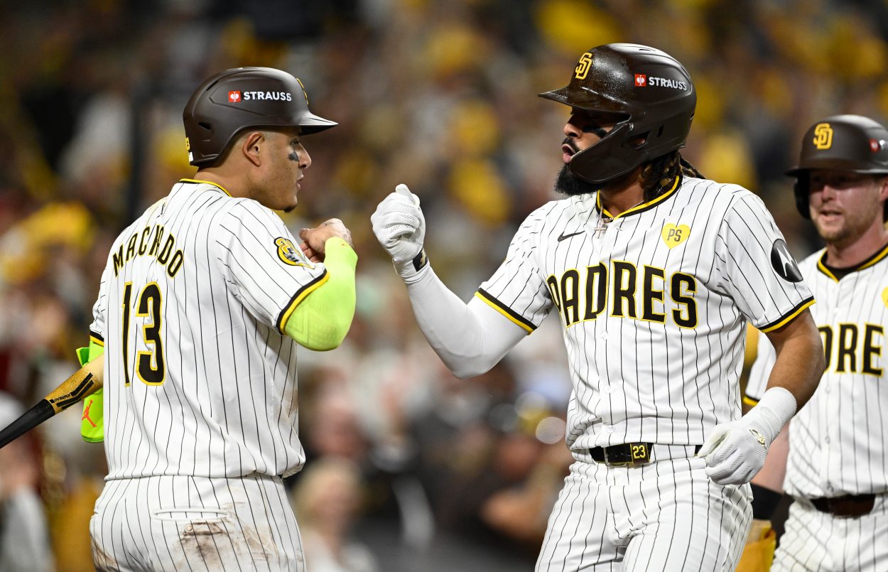 Oct 8, 2024; San Diego, California, USA; San Diego Padres outfielder Fernando Tatis Jr. (23) celebrates with third baseman Manny Machado (13) after hitting a home run in the second inning against the Los Angeles Dodgers during game three of the NLDS for the 2024 MLB Playoffs at Petco Park.  Mandatory Credit: Denis Poroy-Imagn Images