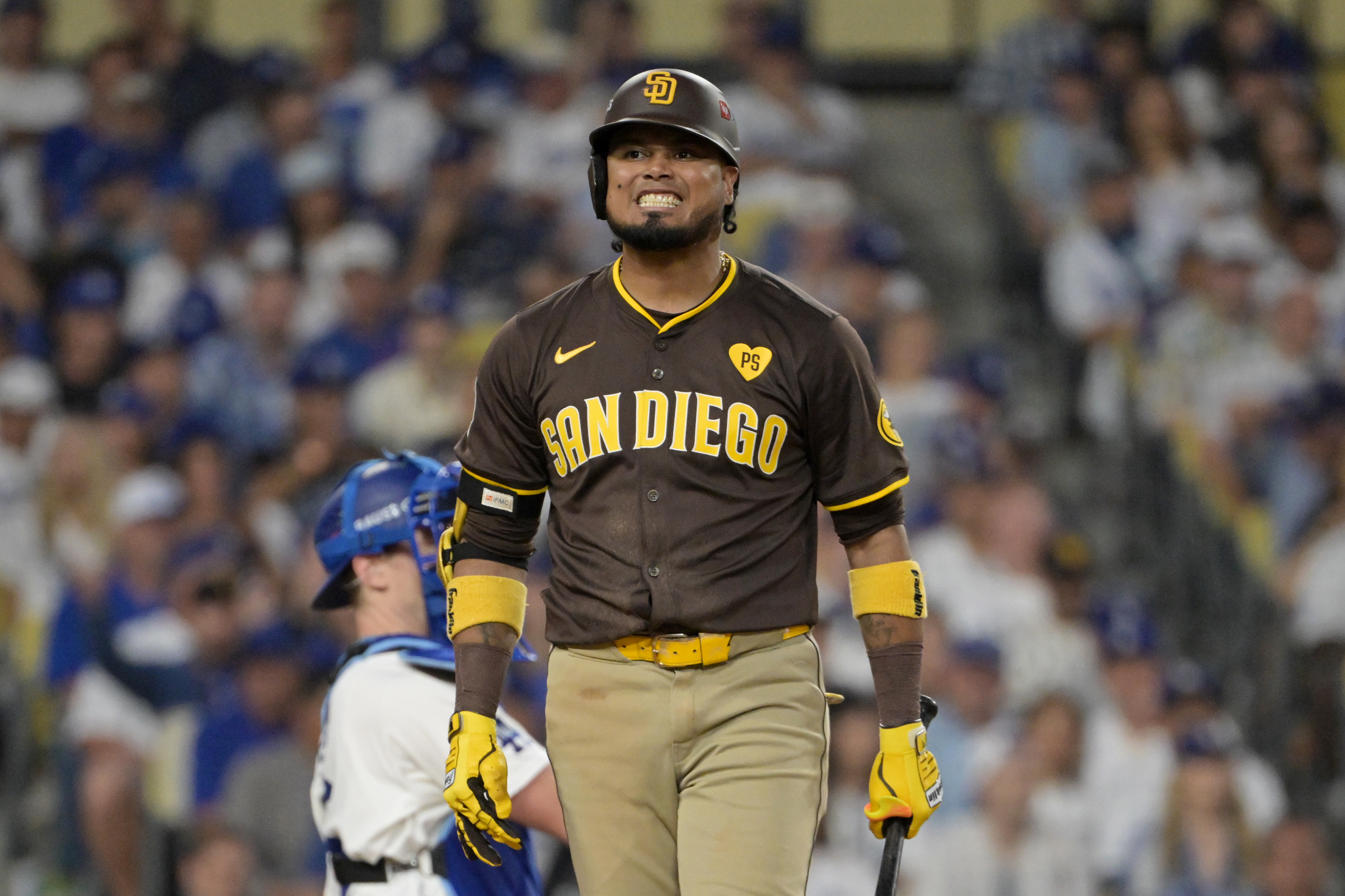 Oct 11, 2024; Los Angeles, California, USA; San Diego Padres first baseman Luis Arraez (4) reacts at bat in the sixth inning against the Los Angeles Dodgers during game five of the NLDS for the 2024 MLB Playoffs at Dodger Stadium. Mandatory Credit: Jayne Kamin-Oncea-Imagn Images