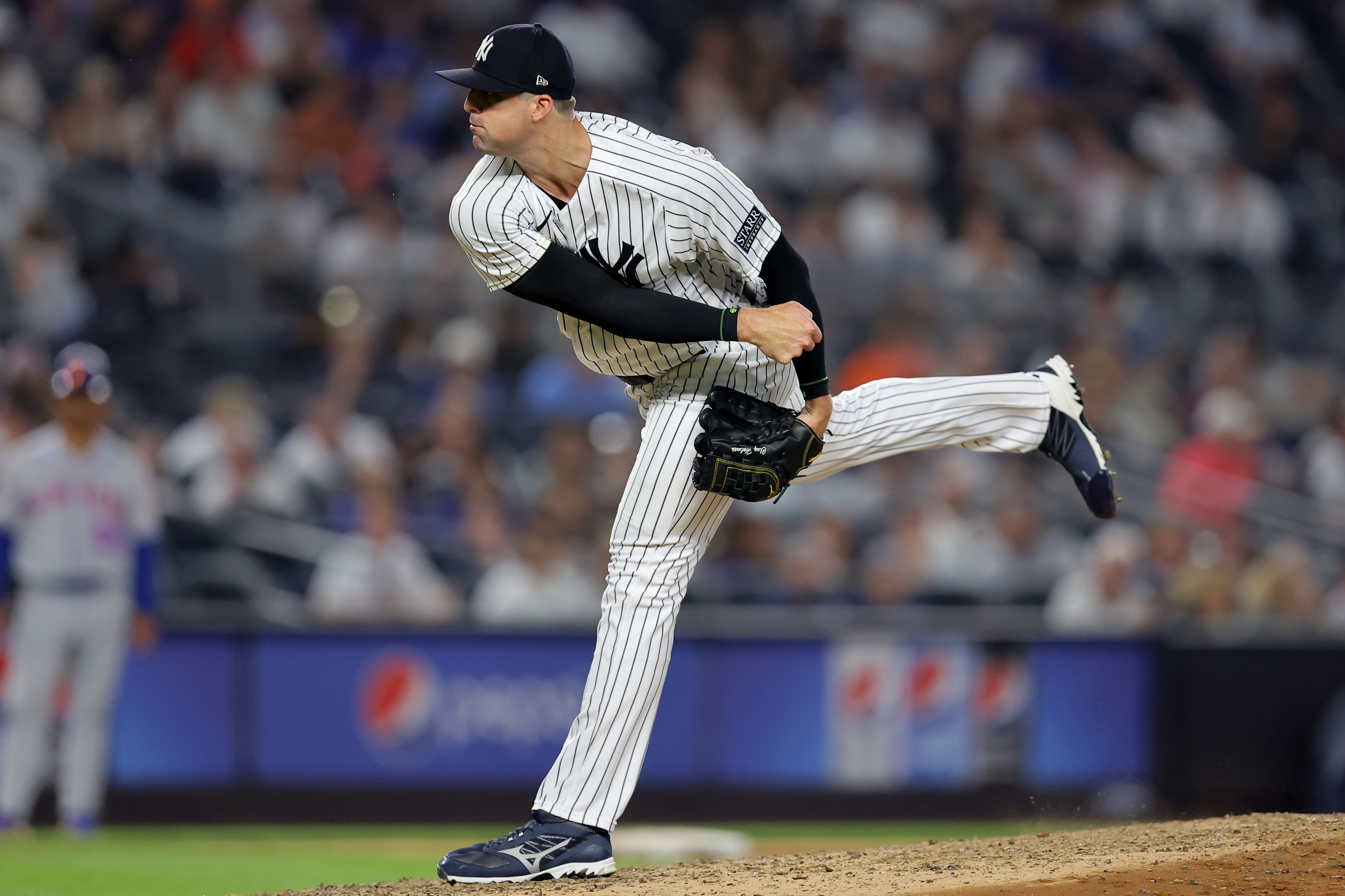 Jul 26, 2023; Bronx, New York, USA; New York Yankees relief pitcher Clay Holmes (35) follows through on a pitch against the New York Mets during the ninth inning at Yankee Stadium. Mandatory Credit: Brad Penner-Imagn Images