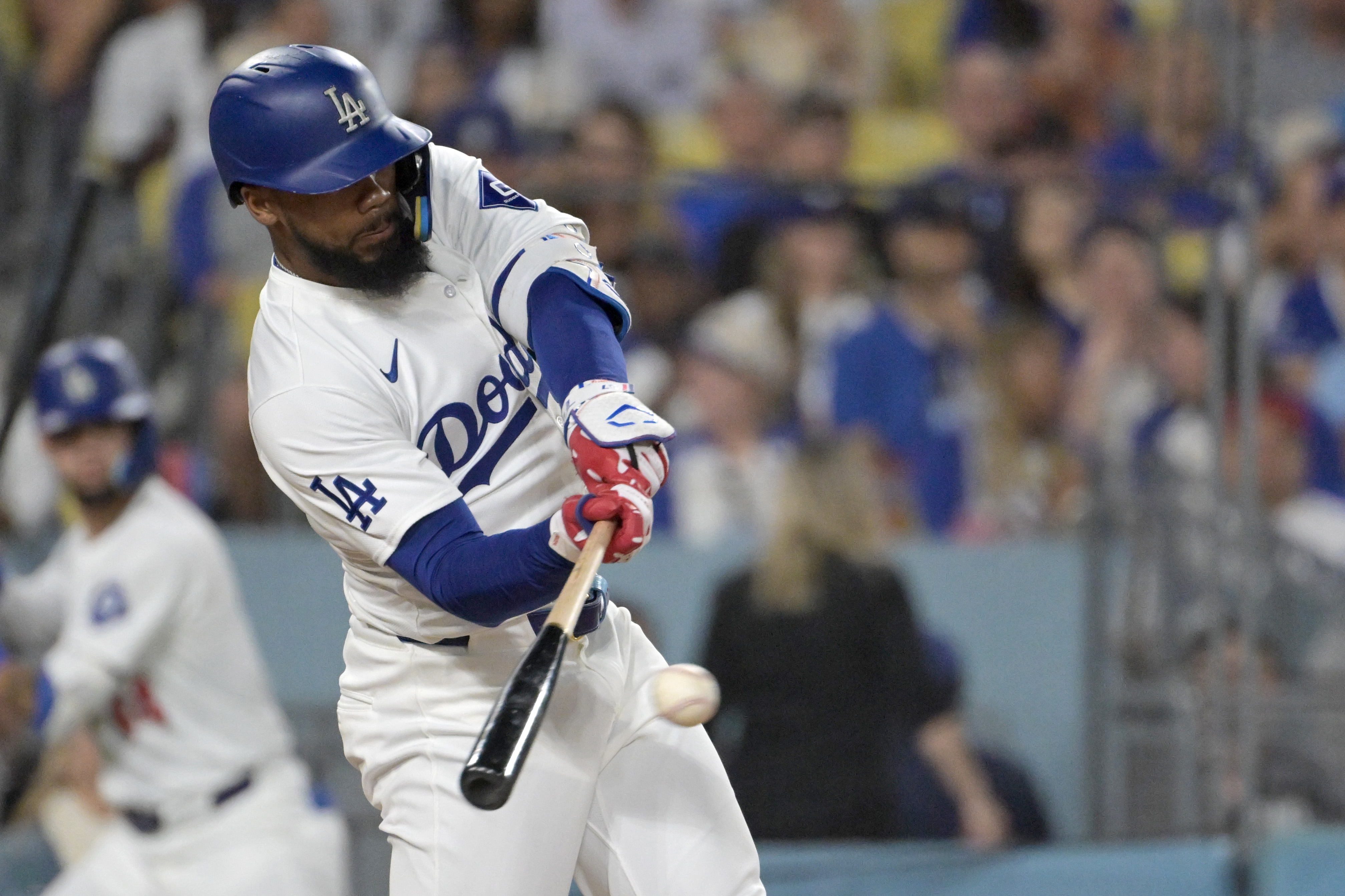 Jul 22, 2024; Los Angeles, California, USA; Los Angeles Dodgers left fielder Teoscar Hernandez (37) hits a RBI single in the sixth inning against the San Fransisco Giants at Dodger Stadium. Mandatory Credit: Jayne Kamin-Oncea-Imagn Images