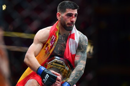 Feb 17, 2024; Anaheim, California, USA; Ilia Topuria celebrates his championship victory against Alexander Volkanovski during UFC 298 at Honda Center. Mandatory Credit: Gary A. Vasquez-Imagn Images