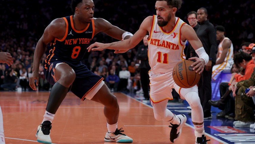 Dec 11, 2024; New York, New York, USA; Atlanta Hawks guard Trae Young (11) controls the ball against New York Knicks forward OG Anunoby (8) during the second quarter at Madison Square Garden. Mandatory Credit: Brad Penner-Imagn Images