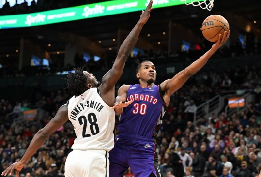 Dec 19, 2024; Toronto, Ontario, CAN;  Toronto Raptors guard Ochai Agbaji (30) shoots the ball as Brooklyn Nets forward Dorian Finney-Smith (28) defends in the second half at Scotiabank Arena. Mandatory Credit: Dan Hamilton-Imagn Images