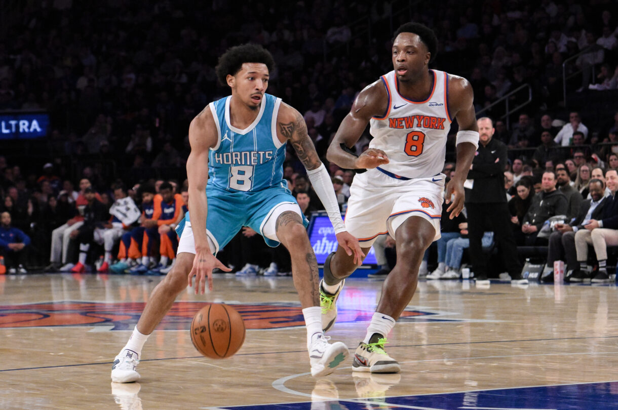 Dec 5, 2024; New York, New York, USA; Charlotte Hornets guard Nick Smith Jr. (8) drives to the basket while being defended by New York Knicks forward OG Anunoby (8) during the first half at Madison Square Garden. Mandatory Credit: John Jones-Imagn Images