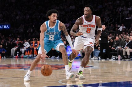 Dec 5, 2024; New York, New York, USA; Charlotte Hornets guard Nick Smith Jr. (8) drives to the basket while being defended by New York Knicks forward OG Anunoby (8) during the first half at Madison Square Garden. Mandatory Credit: John Jones-Imagn Images