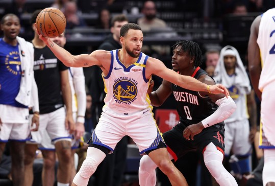 Dec 11, 2024; Houston, Texas, USA; Golden State Warriors guard Stephen Curry (30) controls the ball as Houston Rockets guard Aaron Holiday (0) defends during the fourth quarter at Toyota Center. Mandatory Credit: Troy Taormina-Imagn Images