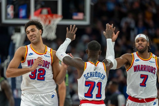 Dec 21, 2024; Minneapolis, Minnesota, USA; Golden State Warriors forward Trayce Jackson-Davis (32) celebrates with guard Dennis Schroder (71) and guard Buddy Hield (7) after making a shot against the Minnesota Timberwolves in the first half at Target Center. Mandatory Credit: Jesse Johnson-Imagn Images