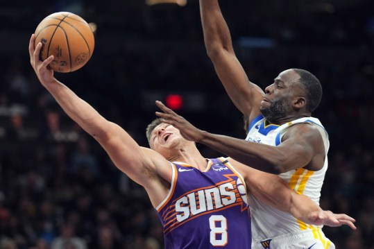 Nov 30, 2024; Phoenix, Arizona, USA; Phoenix Suns guard Grayson Allen (8) goes up for a layup against Golden State Warriors forward Draymond Green (23) during the second half at Footprint Center. Mandatory Credit: Joe Camporeale-Imagn Images