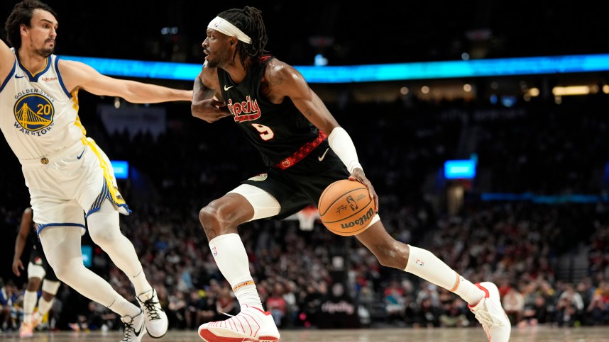 Dec 17, 2023; Portland, Oregon, USA; Portland Trail Blazers small forward Jerami Grant (9) dribbles the ball while defended by Golden State Warriors power forward Dario Saric (20) during the second half at Moda Center. Mandatory Credit: Soobum Im-Imagn Images