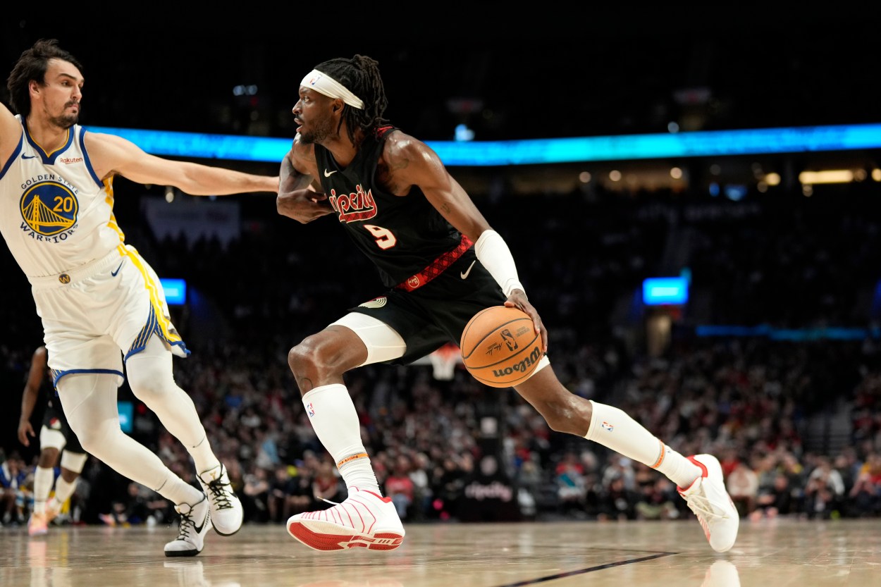 Dec 17, 2023; Portland, Oregon, USA; Portland Trail Blazers small forward Jerami Grant (9) dribbles the ball while defended by Golden State Warriors power forward Dario Saric (20) during the second half at Moda Center. Mandatory Credit: Soobum Im-Imagn Images