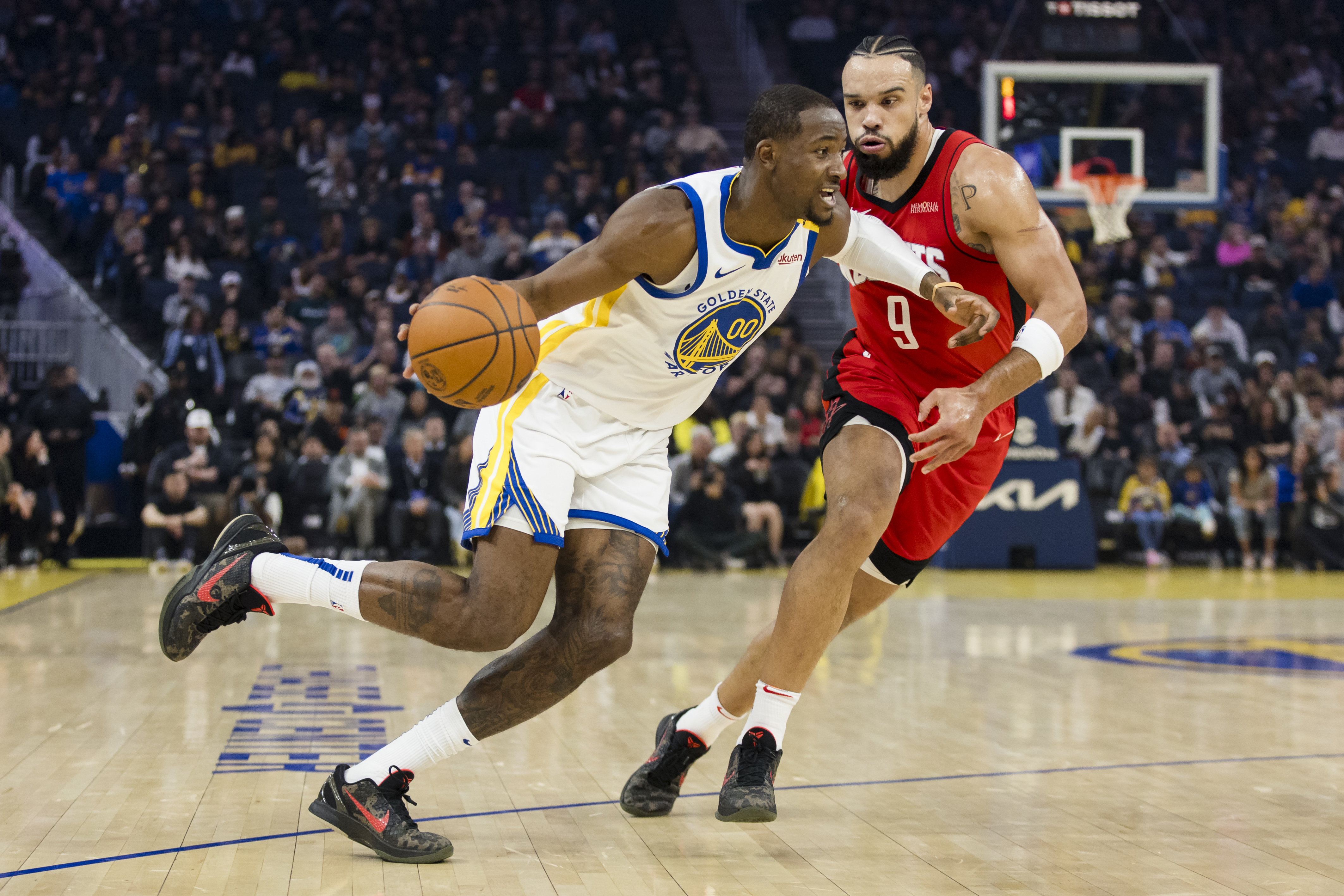 Dec 5, 2024; San Francisco, California, USA;  Golden State Warriors forward Jonathan Kuminga (00) drives past Houston Rockets forward Dillon Brooks (9) during the first quarter at Chase Center. Mandatory Credit: John Hefti-Imagn Images