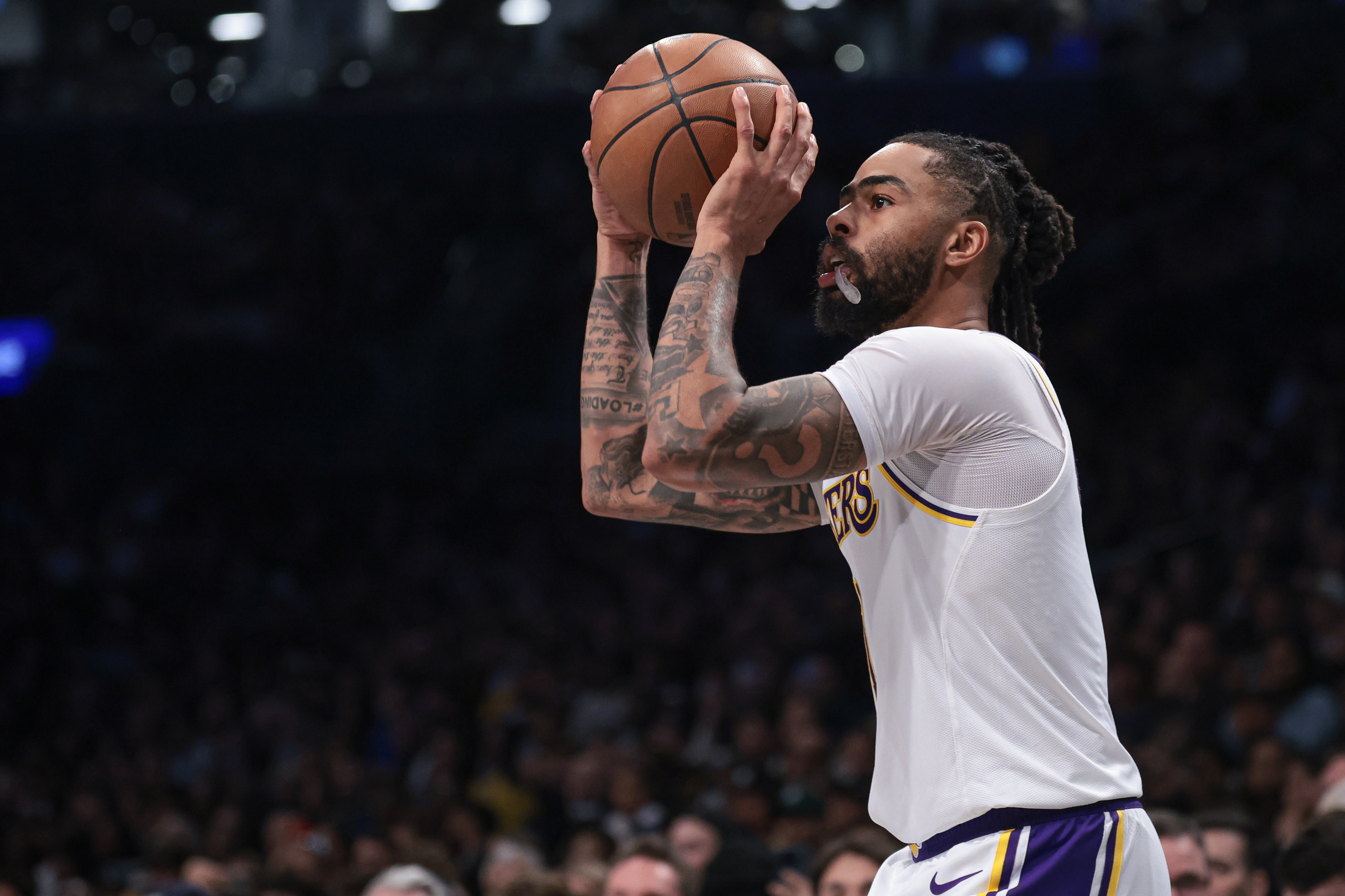 Mar 31, 2024; Brooklyn, New York, USA; Los Angeles Lakers guard D'Angelo Russell (1) shoots during the second half against the Brooklyn Nets at Barclays Center. Mandatory Credit: Vincent Carchietta-Imagn Images