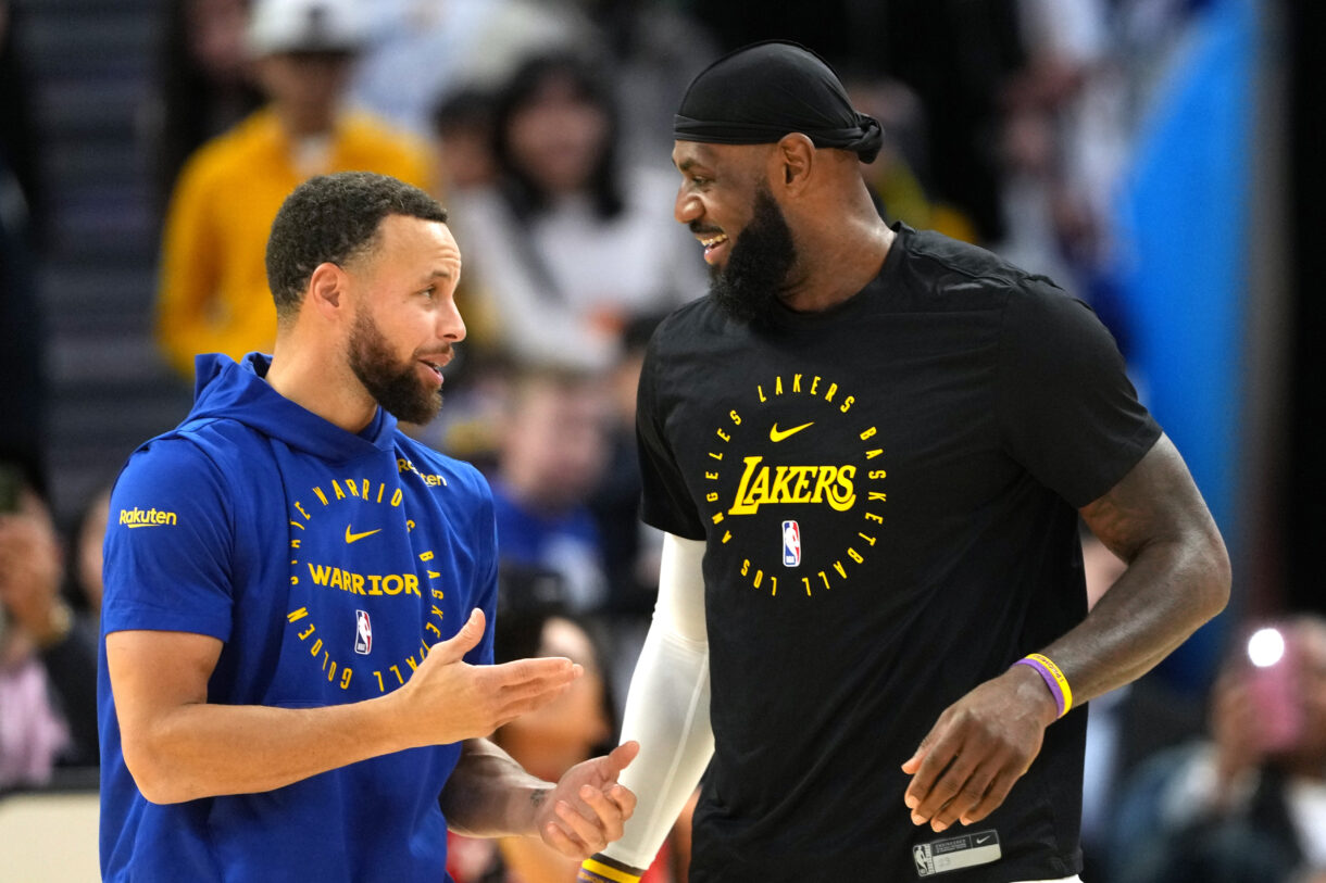 Dec 25, 2024; San Francisco, California, USA; Golden State Warriors guard Stephen Curry (left) and Los Angeles Lakers forward LeBron James (right) talk before the game at Chase Center. Mandatory Credit: Darren Yamashita-Imagn Images