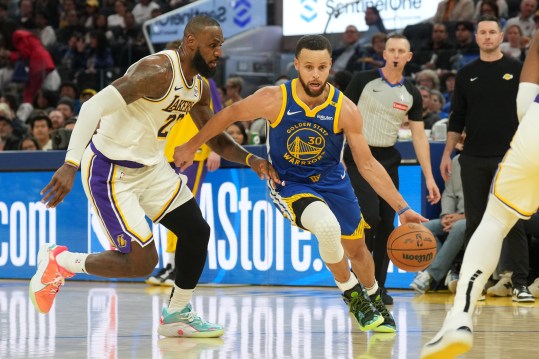 Dec 25, 2024; San Francisco, California, USA; Golden State Warriors guard Stephen Curry (30) dribbles against Los Angeles Lakers forward LeBron James (left) during the third quarter at Chase Center. Mandatory Credit: Darren Yamashita-Imagn Images