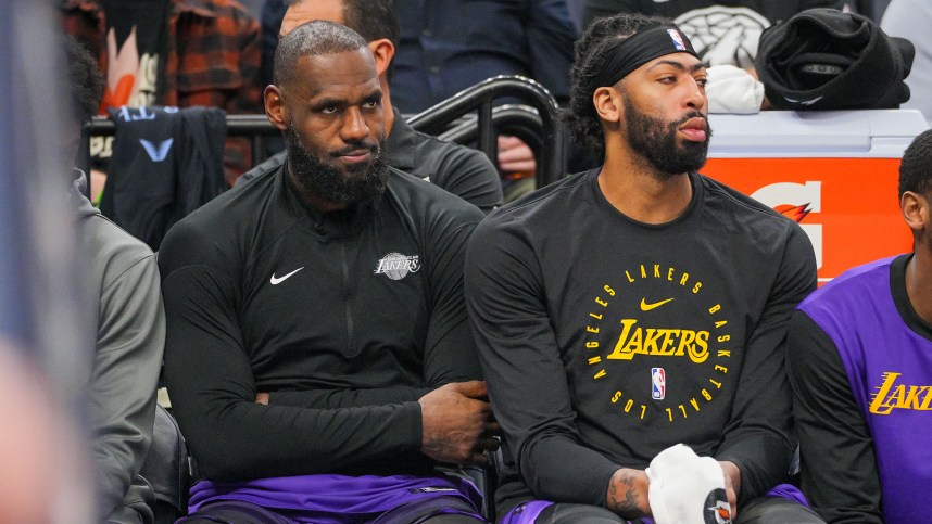 Dec 2, 2024; Minneapolis, Minnesota, USA; Los Angeles Lakers forward LeBron James (23) and forward Anthony Davis (3) on the bench against the Minnesota Timberwolves in the fourth quarter at Target Center. Mandatory Credit: Brad Rempel-Imagn Images