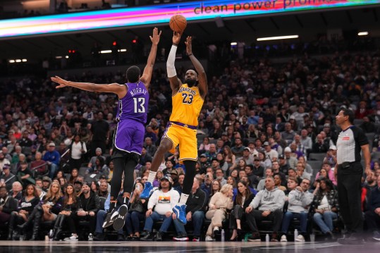 Dec 19, 2024; Sacramento, California, USA; Los Angeles Lakers forward LeBron James (23) shoots over Sacramento Kings forward Keegan Murray (13) in the first quarter at the Golden 1 Center. Mandatory Credit: Cary Edmondson-Imagn Images