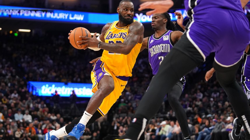 Dec 19, 2024; Sacramento, California, USA; Los Angeles Lakers forward LeBron James (23) drives past Sacramento Kings guard Keon Ellis (23) in the second quarter at the Golden 1 Center. Mandatory Credit: Cary Edmondson-Imagn Images