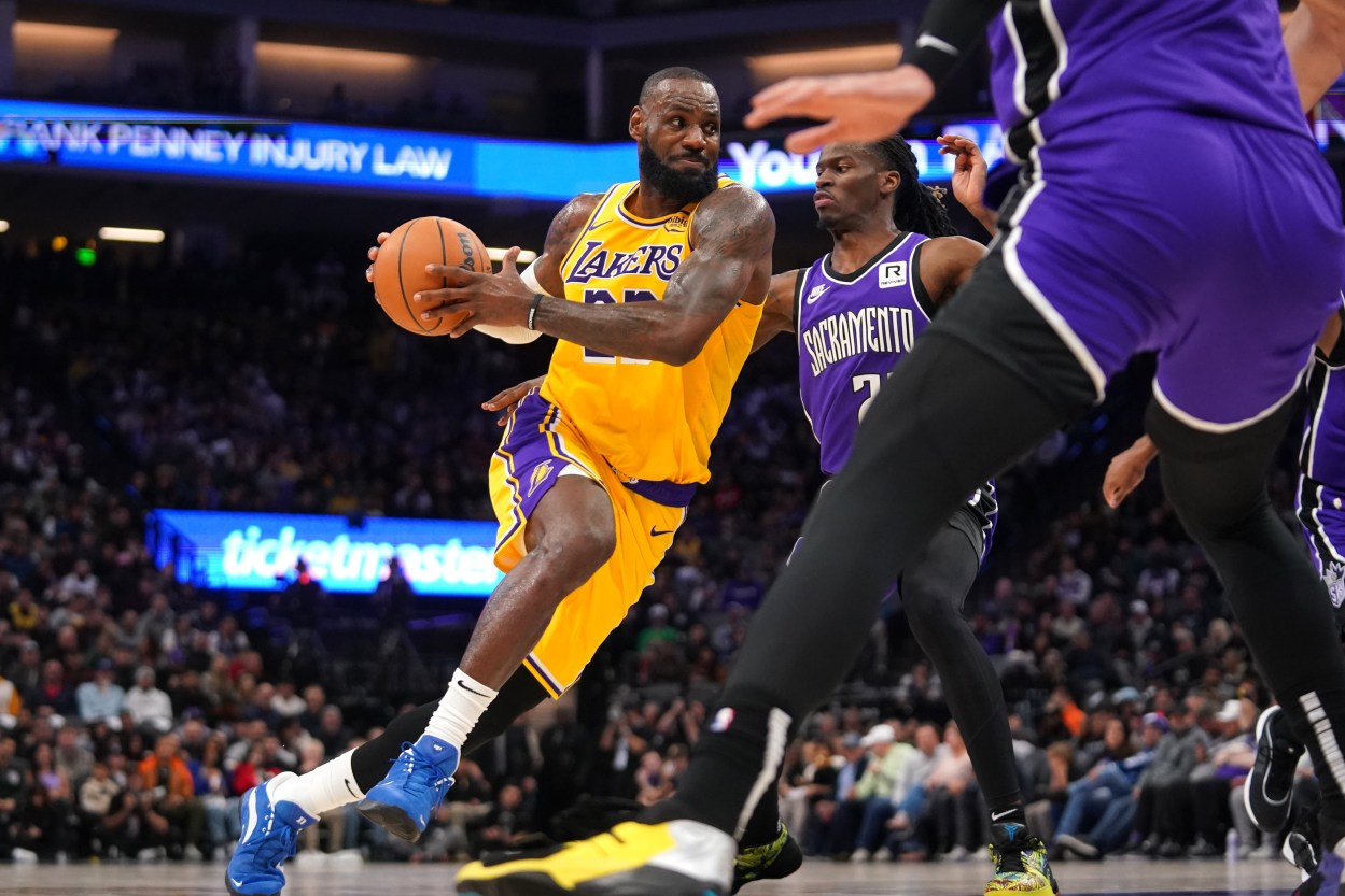 Dec 19, 2024; Sacramento, California, USA; Los Angeles Lakers forward LeBron James (23) drives past Sacramento Kings guard Keon Ellis (23) in the second quarter at the Golden 1 Center. Mandatory Credit: Cary Edmondson-Imagn Images