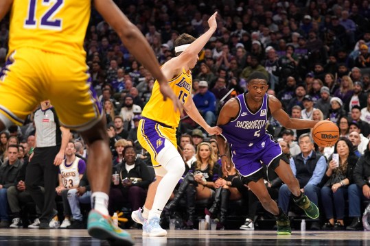 Dec 19, 2024; Sacramento, California, USA; Sacramento Kings guard De'Aaron Fox (5) dribbles the ball next to Los Angeles Lakers guard Austin Reaves (15) in the fourth quarter at the Golden 1 Center. Mandatory Credit: Cary Edmondson-Imagn Images