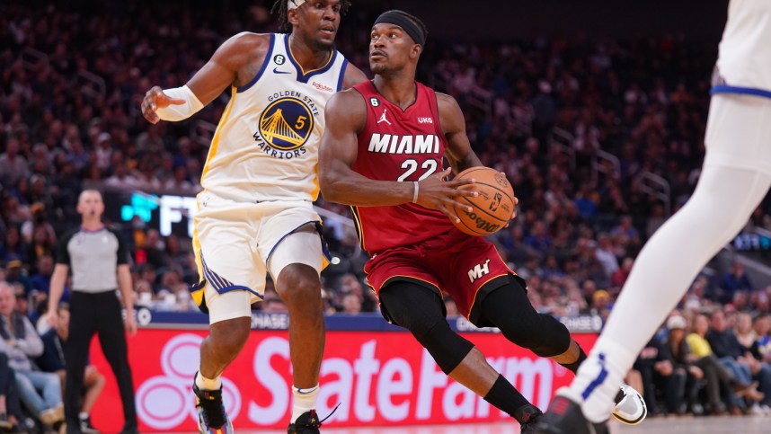 Oct 27, 2022; San Francisco, California, USA; Miami Heat forward Jimmy Butler (22) drives past Golden State Warriors forward Kevon Looney (5) in the fourth quarter at the Chase Center. Mandatory Credit: Cary Edmondson-Imagn Images