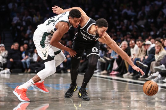 Oct 27, 2024; Brooklyn, New York, USA;  Milwaukee Bucks forward Giannis Antetokounmpo (34) and Brooklyn Nets guard Ben Simmons (10) fight for a loose ball in the fourth quarter at Barclays Center. Mandatory Credit: Wendell Cruz-Imagn Images