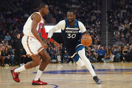 Dec 8, 2024; San Francisco, California, USA;  Minnesota Timberwolves forward-center Julius Randle (30) drives to the basket against Golden State Warriors forward Jonathan Kuminga (00) in the first period at Chase Center. Mandatory Credit: David Gonzales-Imagn Images