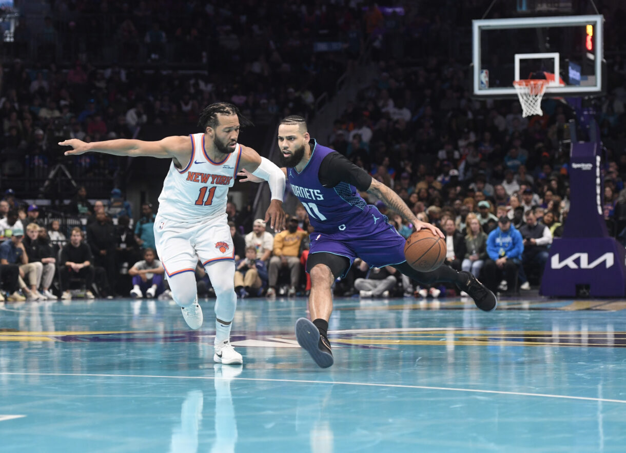Nov 29, 2024; Charlotte, North Carolina, USA;  Charlotte Hornets forward Cody Martin (11) drives past New York Knicks guard Jalen Brunson (11) during the second half at the Spectrum Center. Mandatory Credit: Sam Sharpe-Imagn Images