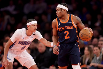 Dec 3, 2024; New York, New York, USA; New York Knicks guard Miles McBride (2) controls the ball against Orlando Magic guard Anthony Black (0) during the first quarter at Madison Square Garden. Mandatory Credit: Brad Penner-Imagn Images