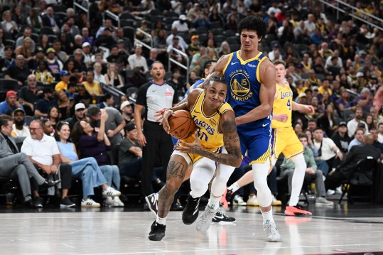 Oct 15, 2024; Las Vegas, Nevada, USA; Los Angeles Lakers forward Maxwell Lewis (20) is fouled by Golden State Warriors forward Gui Santos (15) in the fourth quarter of their preseason game at T-Mobile Arena. Mandatory Credit: Candice Ward-Imagn Images