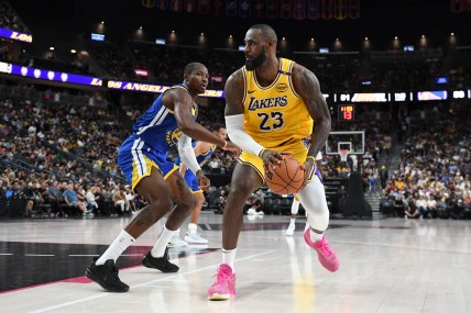 Oct 15, 2024; Las Vegas, Nevada, USA; Los Angeles Lakers forward LeBron James (23) dribbles past Golden State Warriors forward Jonathan Kuminga (00) in the third quarter during a preseason game at T-Mobile Arena. Mandatory Credit: Candice Ward-Imagn Images