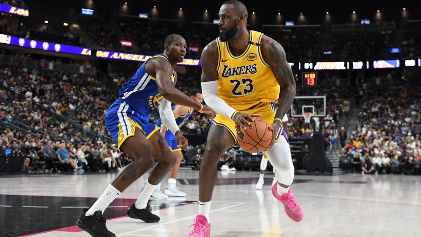 Oct 15, 2024; Las Vegas, Nevada, USA; Los Angeles Lakers forward LeBron James (23) dribbles past Golden State Warriors forward Jonathan Kuminga (00) in the third quarter during a preseason game at T-Mobile Arena. Mandatory Credit: Candice Ward-Imagn Images