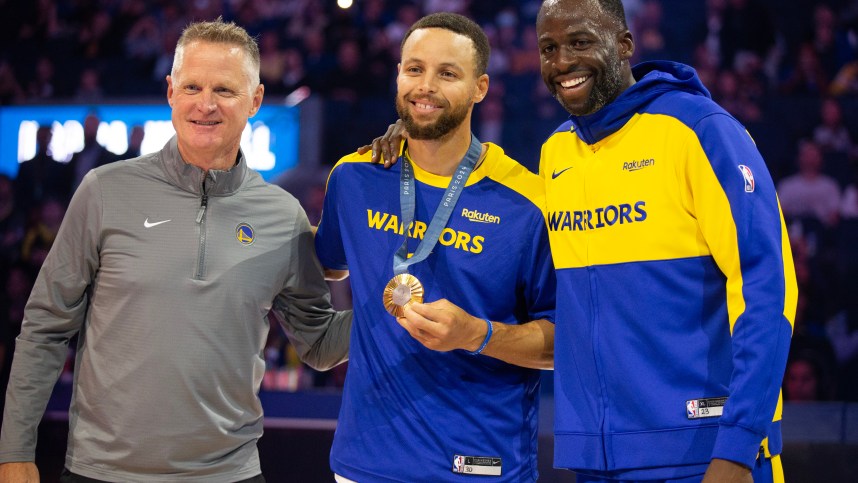 Oct 11, 2024; San Francisco, California, USA; Golden State Warriors guard Stephen Curry (center) is flanked by head coach Steve Kerr and forward Draymond Green as he is presented his gold medal for his performance for Team USA at the 2024 Summer Olympics in Paris before taking on the Sacramento Kings at Chase Center. Mandatory Credit: D. Ross Cameron-Imagn Images