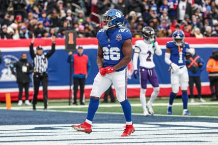 Dec 15, 2024; East Rutherford, New Jersey, USA; New York Giants running back Devin Singletary (26) celebrates after his rushing touchdown during the first half against the Baltimore Ravens at MetLife Stadium. Mandatory Credit: Vincent Carchietta-Imagn Images