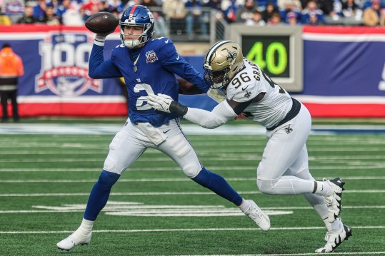 Dec 8, 2024; East Rutherford, New Jersey, USA; New York Giants quarterback Drew Lock (2) is hurried by New Orleans Saints defensive end Carl Granderson (96) during the first quarter at MetLife Stadium. Mandatory Credit: Vincent Carchietta-Imagn Images