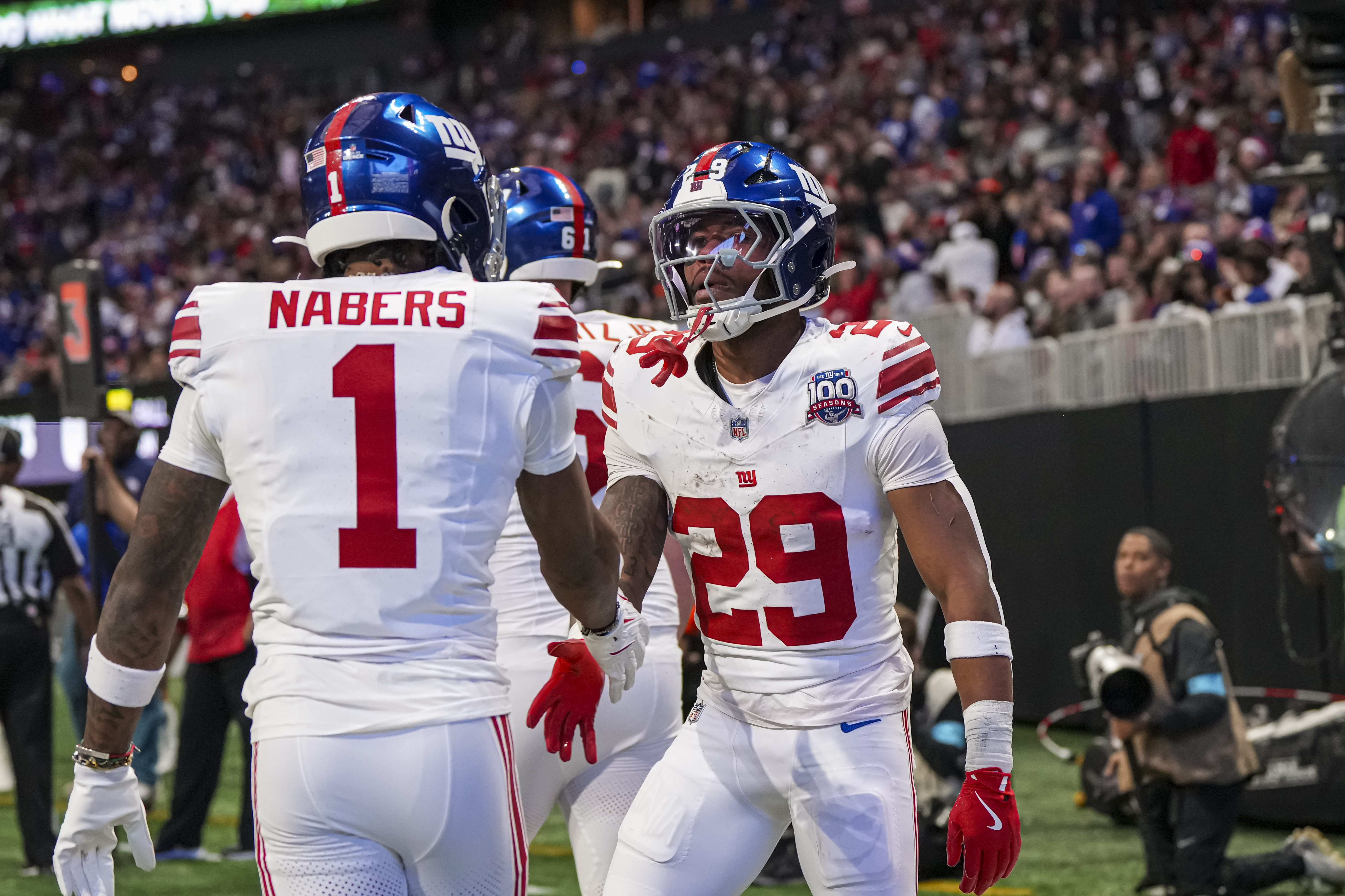 Dec 22, 2024; Atlanta, Georgia, USA; New York Giants running back Tyrone Tracy Jr. (29) reacts with wide receiver Malik Nabers (1) after catching a touchdown pass against the Atlanta Falcons during the first half at Mercedes-Benz Stadium. Mandatory Credit: Dale Zanine-Imagn Images