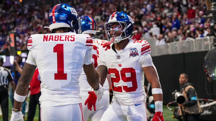 Dec 22, 2024; Atlanta, Georgia, USA; New York Giants running back Tyrone Tracy Jr. (29) reacts with wide receiver Malik Nabers (1) after catching a touchdown pass against the Atlanta Falcons during the first half at Mercedes-Benz Stadium. Mandatory Credit: Dale Zanine-Imagn Images