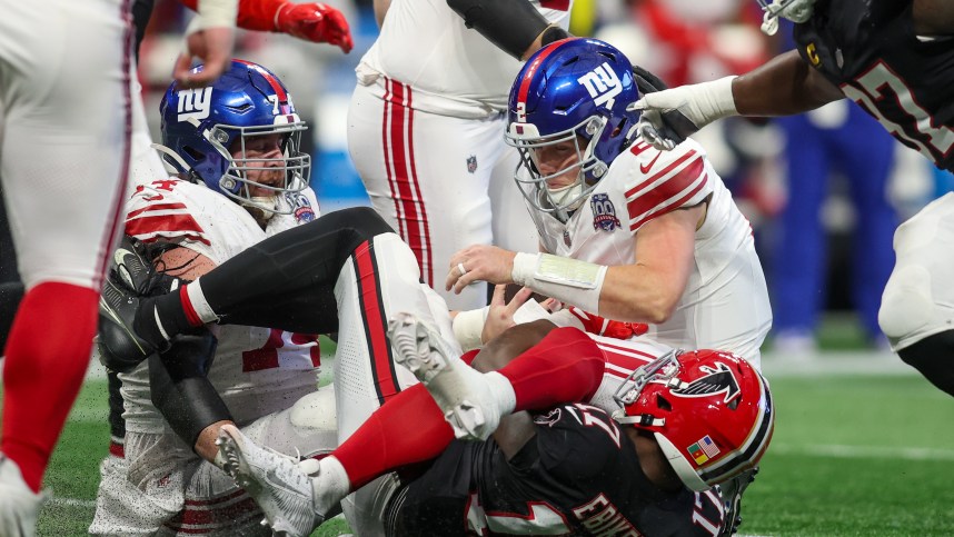 Dec 22, 2024; Atlanta, Georgia, USA; New York Giants quarterback Drew Lock (2) is sacked by Atlanta Falcons linebacker Arnold Ebiketie (17) in the second quarter at Mercedes-Benz Stadium. Mandatory Credit: Brett Davis-Imagn Images