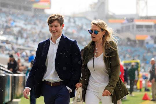 Son of Jets co-owner Woody Johnson, not shown, Brick Johnson, 17, left, walks with mother Suzanne Johnson before an NFL football matchup Sunday, Dec. 15, 2024 at EverBank Stadium in Jacksonville, Fla. [Corey Perrine/Florida Times-Union]