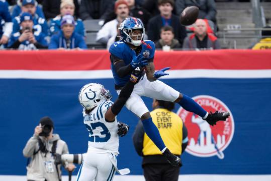 New York Giants wide receiver Malik Nabers (1) catches a pass in the air while being guarded by Indianapolis Colts defensive back Kenny Moore II (23) during a game between New York Giants and Indianapolis Colts at MetLife Stadium on Sunday, Dec. 29, 2024.