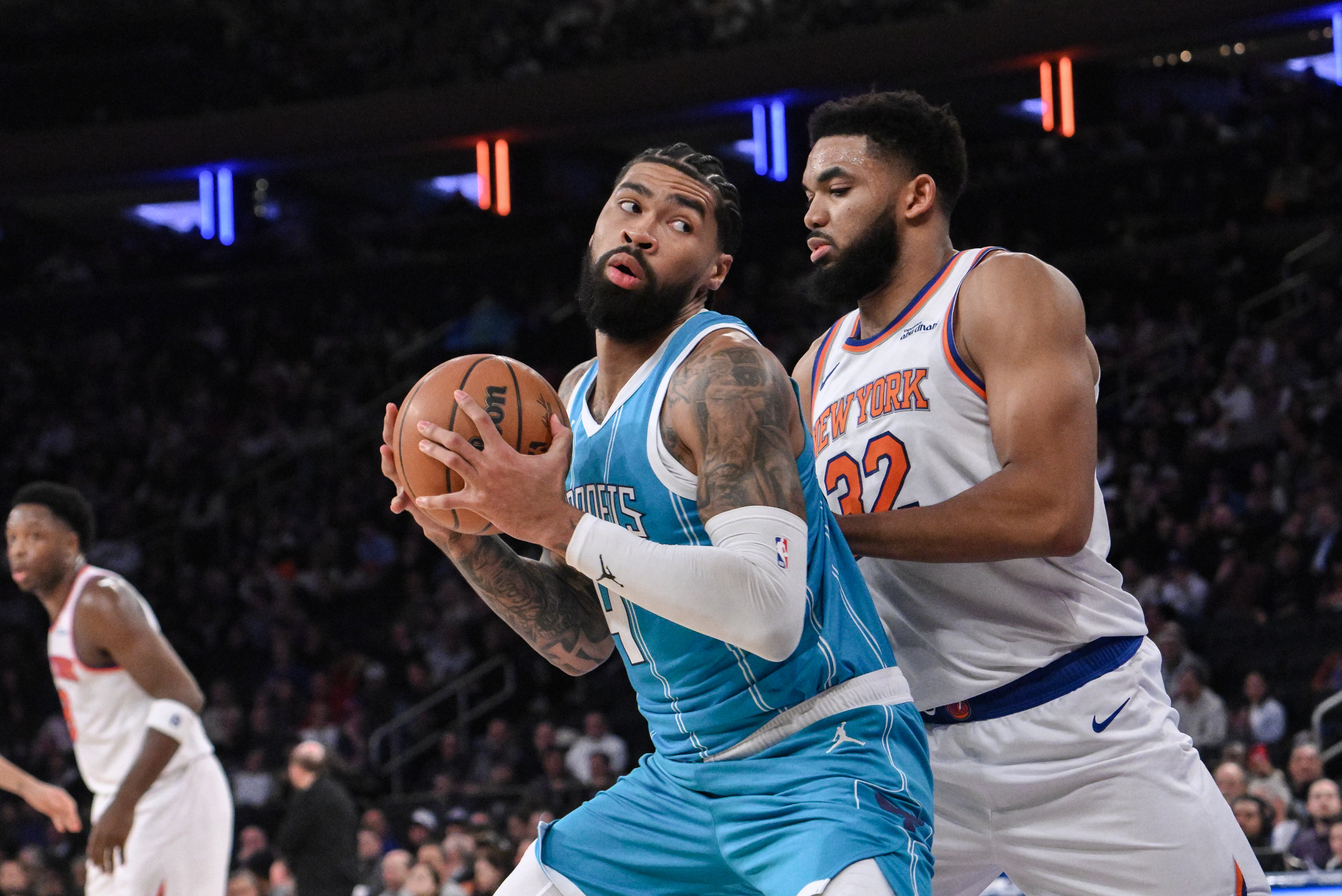 Dec 5, 2024; New York, New York, USA; Charlotte Hornets center Nick Richards (4) posts up against New York Knicks center Karl-Anthony Towns (32) during the first half at Madison Square Garden. Mandatory Credit: John Jones-Imagn Images