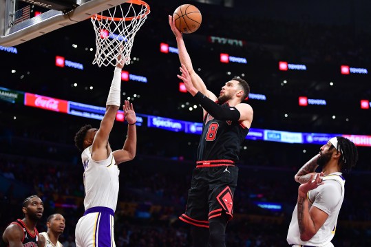 Mar 26, 2023; Los Angeles, California, USA; Chicago Bulls guard Zach LaVine (8) moves to the basket against Los Angeles Lakers forward Troy Brown Jr. (7) and forward Anthony Davis (3) during the second half at Crypto.com Arena. Mandatory Credit: Gary A. Vasquez-Imagn Images