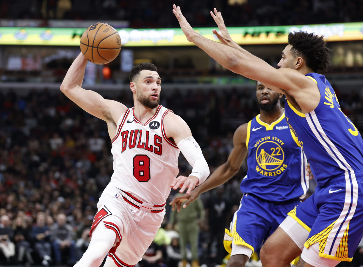 Jan 12, 2024; Chicago, Illinois, USA; Chicago Bulls guard Zach LaVine (8) drives against Golden State Warriors forward Trayce Jackson-Davis (32) during the second half at United Center. Mandatory Credit: Kamil Krzaczynski-Imagn Images