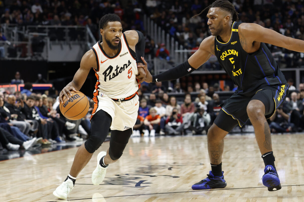 Jan 9, 2025; Detroit, Michigan, USA;  Detroit Pistons guard Malik Beasley (5) dribbles defended by Golden State Warriors forward Kevon Looney (5) in the first half at Little Caesars Arena. Mandatory Credit: Rick Osentoski-Imagn Images