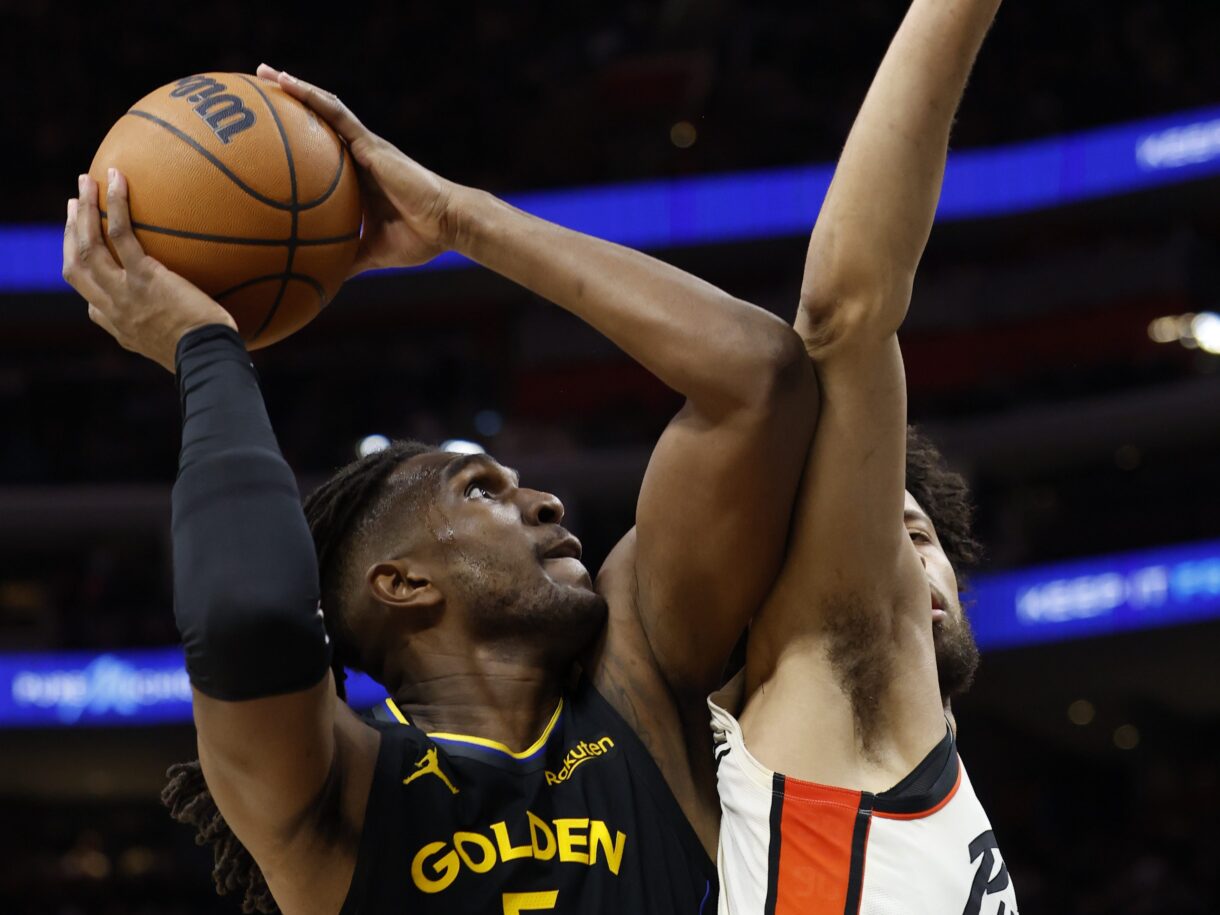 Jan 9, 2025; Detroit, Michigan, USA;  Golden State Warriors forward Kevon Looney (5) shoots against Detroit Pistons guard Cade Cunningham (2) in the second half at Little Caesars Arena. Mandatory Credit: Rick Osentoski-Imagn Images